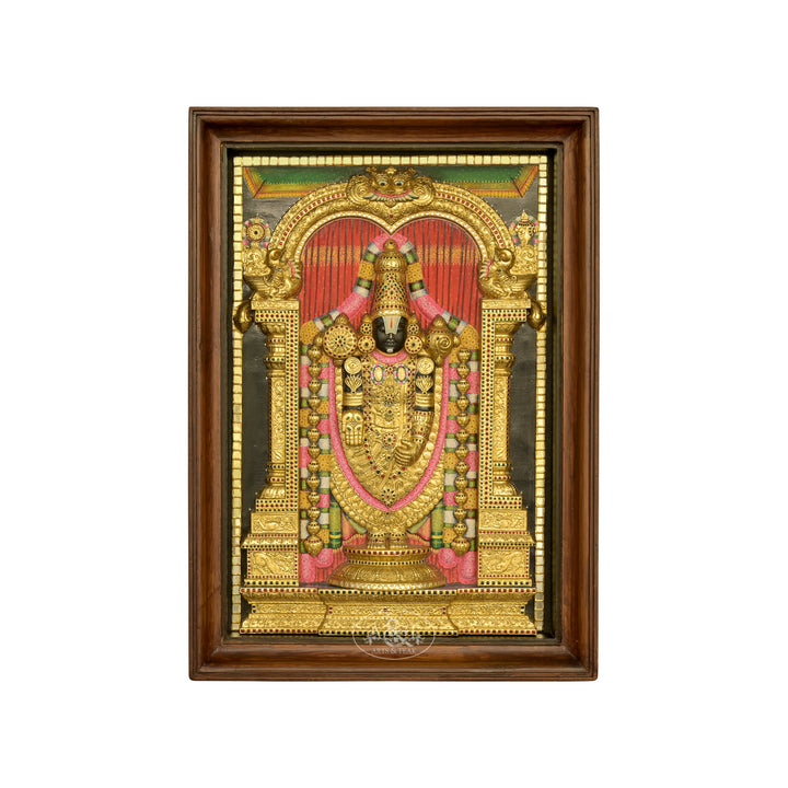 A Tanjore painting depicting Tirupathi Balaji, featuring rich gold colors, intricate handwork, and the deity standing in a temple arch, framed in a wooden frame.