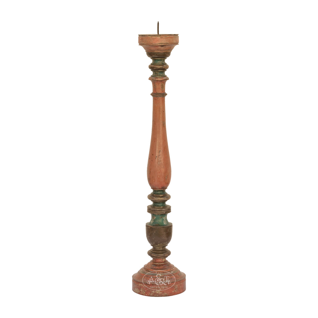 A wooden carved candle stand with a classic spindle design, featuring a distressed green finish.