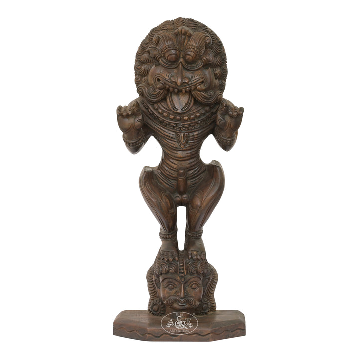 Wooden statue with intricate carvings on a white background