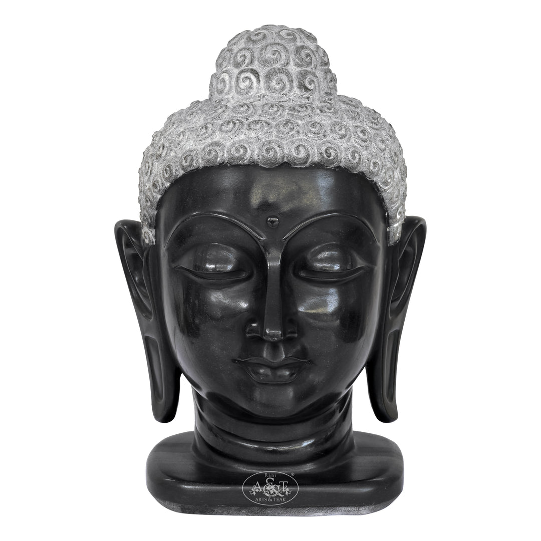 Black Buddha head statue with gray hair on a white background