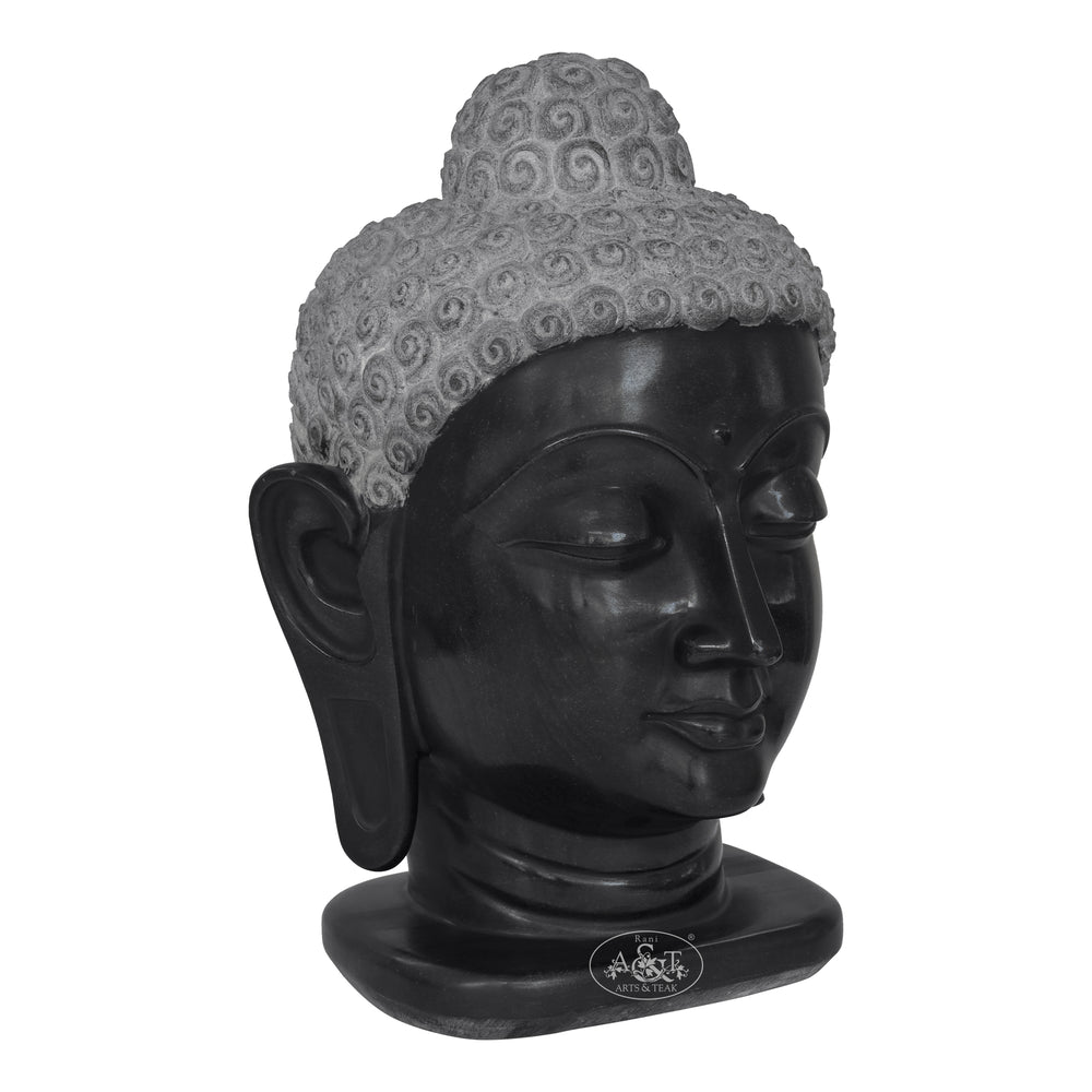 Black Buddha head sculpture with gray hair on a white background