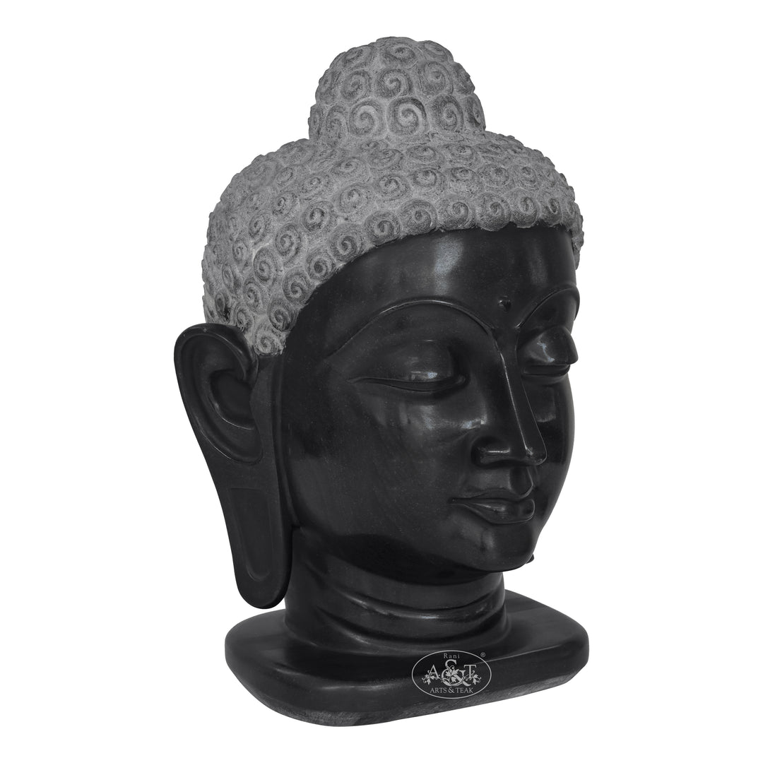 Black Buddha head sculpture with gray hair on a white background