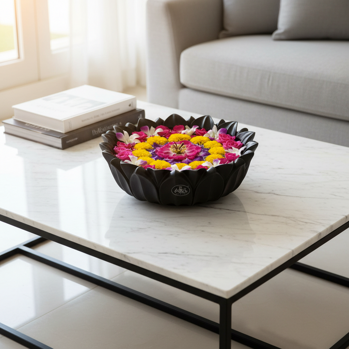 Decorative bowl with colorful flowers on a marble coffee table in a living room.